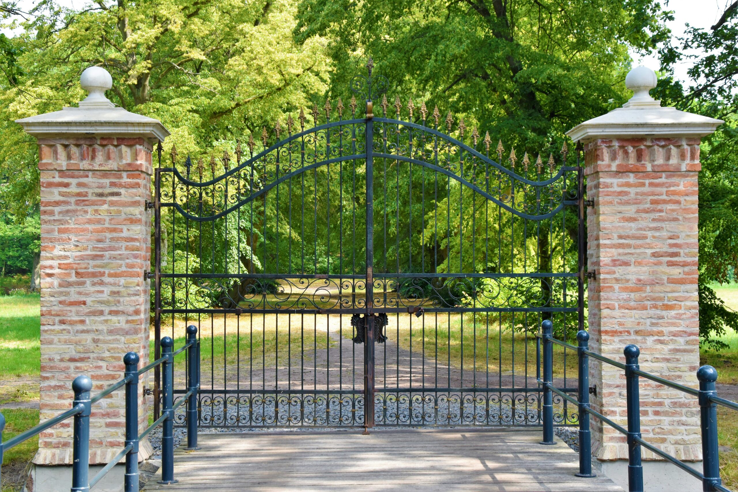 Elegant wrought iron gate with brick pillars, highlighting the rise of automatic gate openers in Fort Worth