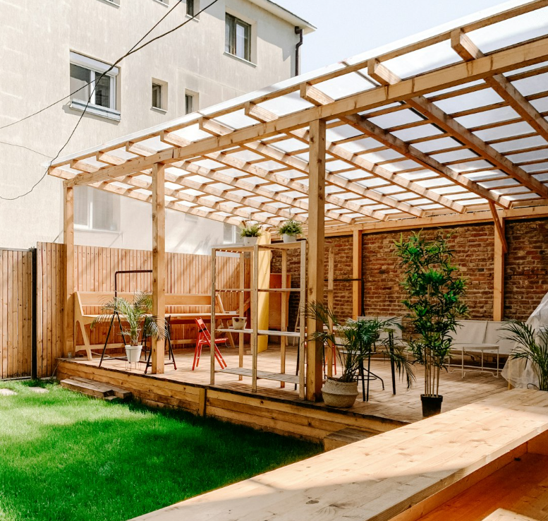 Modern wooden pergola with transparent roof in a Fort Worth TX backyard, showcasing clean lines and customizable outdoor design options.