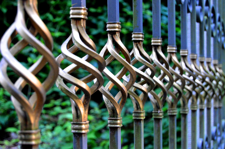 Ornate wrought iron fence detail showcasing elegant twisted metal design in Fort Worth