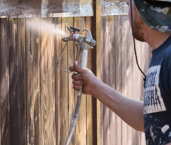 Professional fence staining in Fort Worth by Texas Patio and Fence Co. using weather-resistant stain to protect wood from sun and rain.
