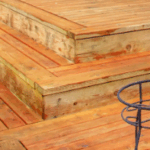 Raised wooden patio deck with wide steps, showcasing expert craftsmanship and durable construction in a Texas backyard.