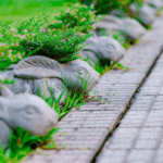 Decorative rabbit-shaped planters lining a garden pathway.