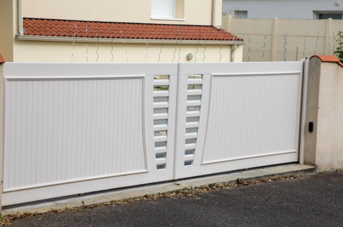 White driveway gate enhancing home security and property value in Texas.