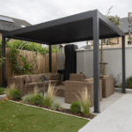 Modern pergola with wicker seating in a landscaped Texas backyard.