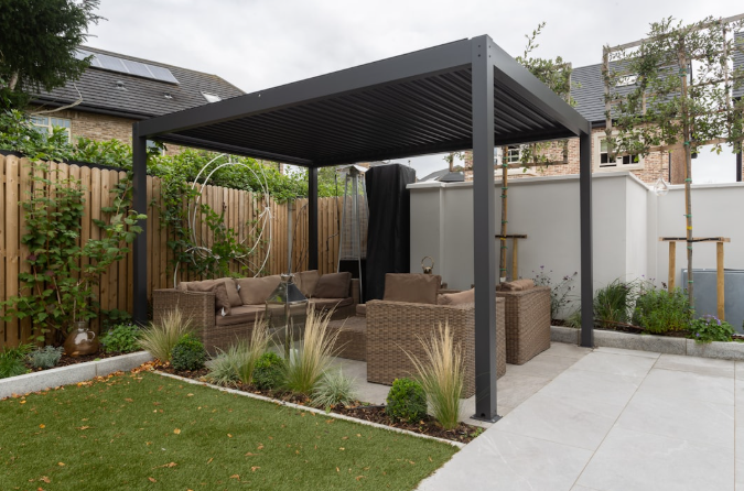Modern pergola with wicker seating in a landscaped Texas backyard.
