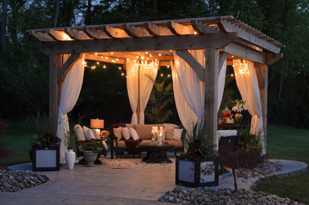 Cozy cedar pergola with string lights and outdoor seating in Fort Worth backyard