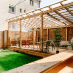 Modern wooden pergola with seating area and greenery in a Fort Worth backyard