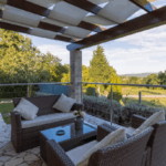Modern outdoor patio with stone flooring and rattan furniture in Fort Worth home