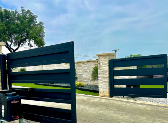 Modern black metal electric gate installed by Texas Patio and Fence, showcasing durable craftsmanship and automated entry design suitable for Texas weather.