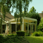 Backyard pergola attached to a home surrounded by greenery in Fort Worth