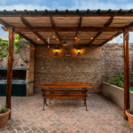 Custom patio installation in Fort Worth featuring a covered brick patio with wooden pergola, built-in seating, and outdoor fireplace